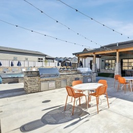 a grill area with tables and chairs