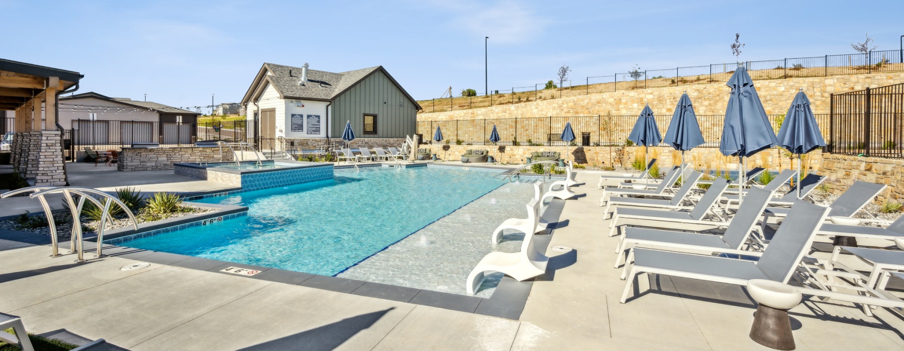 a swimming pool with lounge chairs