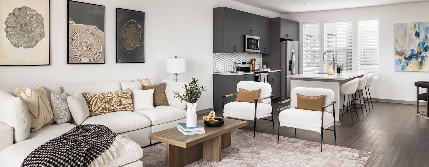 a living room with a couch, coffee table and chairs